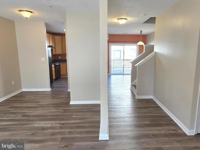 a view of a hallway view with wooden floor and staircase