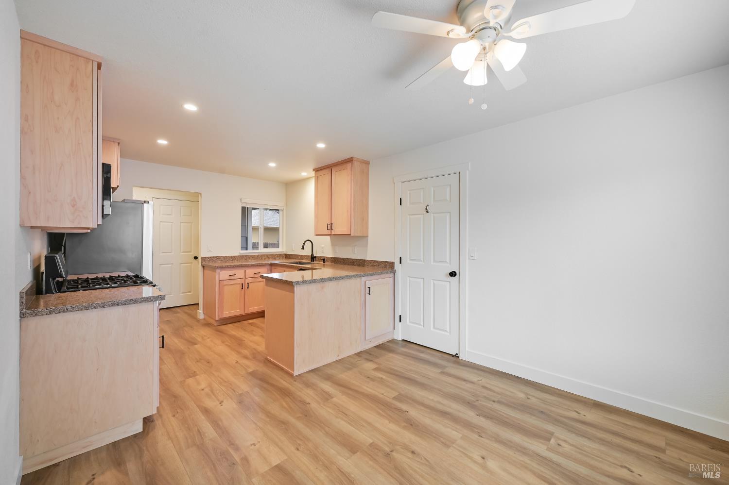 1536 Marlow Road Santa Rosa, CA 95401 - Photo 8 of 21 a kitchen with granite countertop a stove cabinets and wooden floor