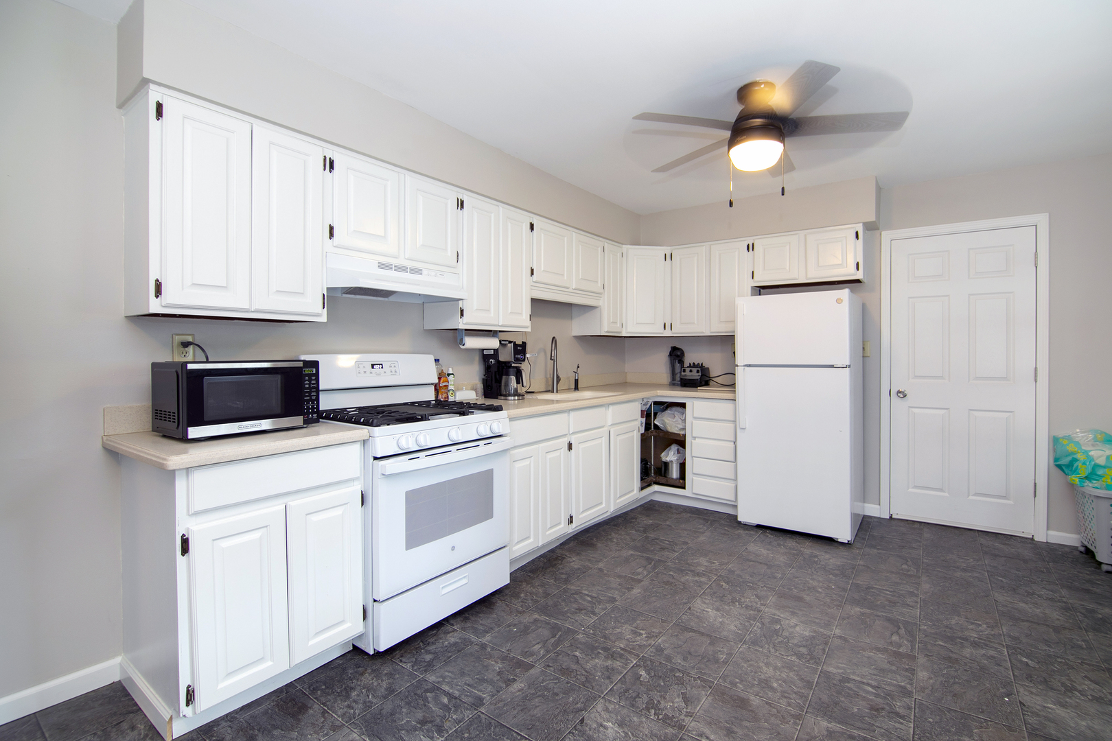 3926 East Chestnut Street Kankakee, IL 60901 - Photo 3 of 14 a kitchen with cabinets and stainless steel appliances