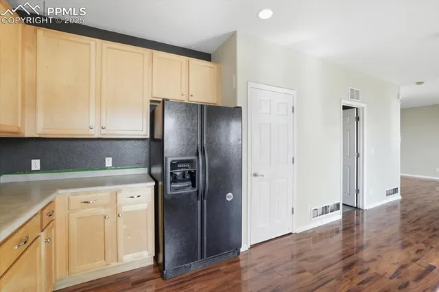 a kitchen with stainless steel appliances granite countertop a refrigerator and a stove top oven