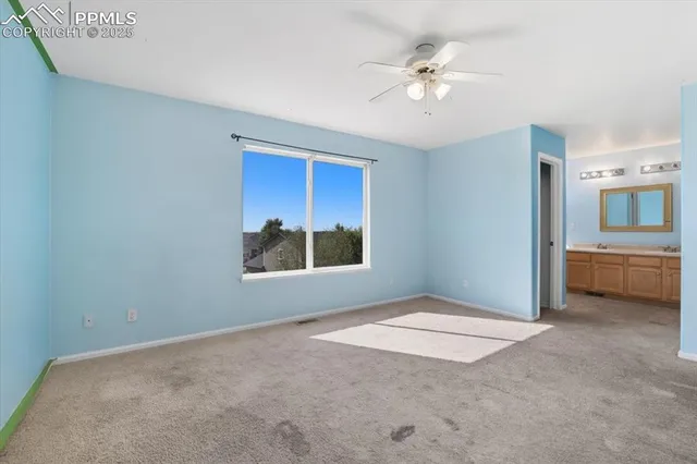 a view of a livingroom with a ceiling fan and window