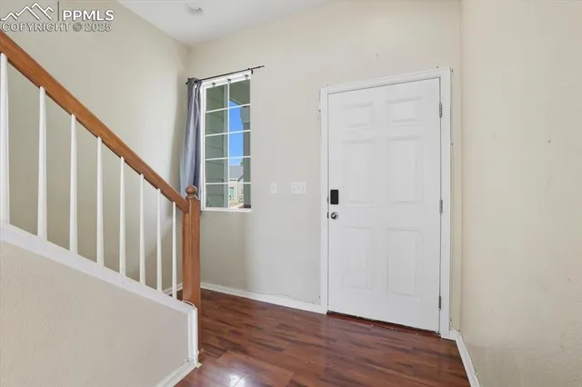 a view of an entryway with wooden floor