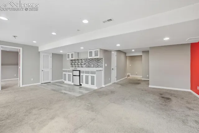 a view of a kitchen with a sink and a refrigerator