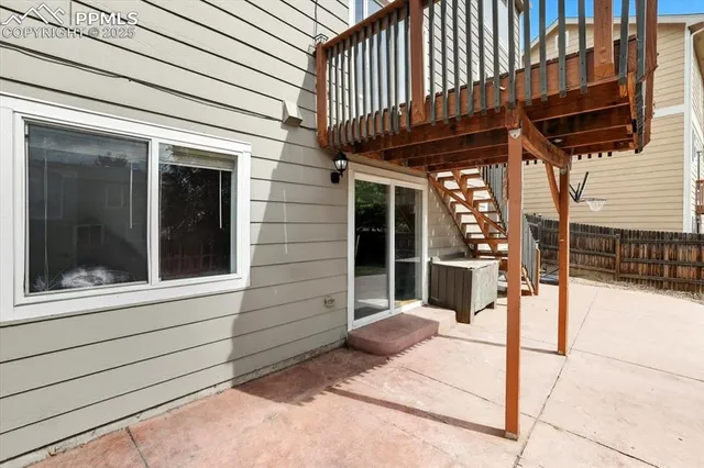 a view of a porch with a table and chairs