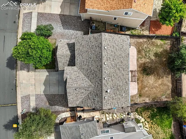 an aerial view of a house with a yard