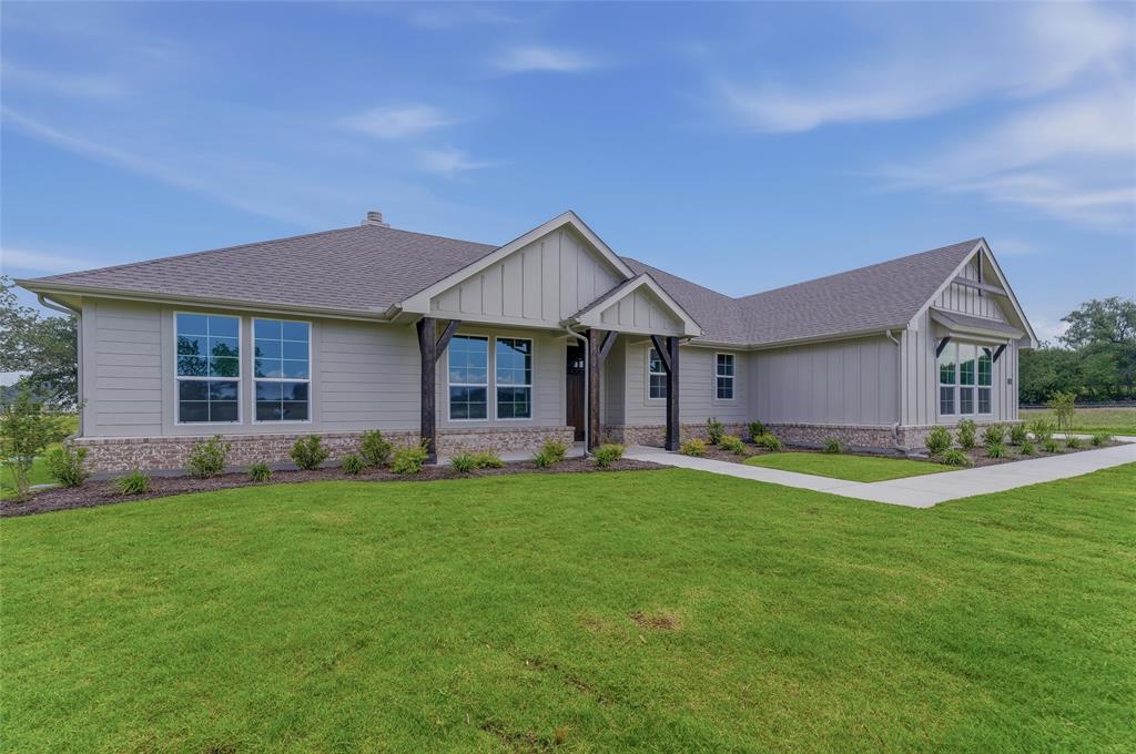 156 Oak Grv Way Springtown, TX 76082 - Photo 2 of 25 Contemporary single-story residence featuring light-toned siding and a stone skirt
