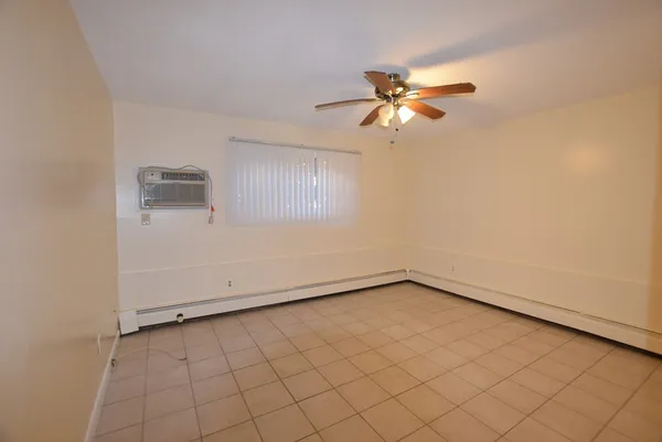 a view of a room with a fan and a window