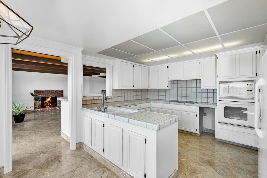 523 Calle Baranda San Clemente, CA 92673 - Photo 13 of 39 a kitchen with stainless steel appliances granite countertop a sink and cabinets