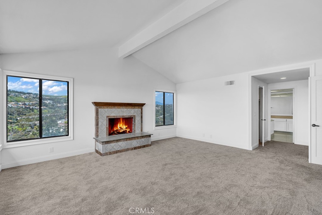 523 Calle Baranda San Clemente, CA 92673 - Photo 20 of 39 an empty room with a fireplace and large window