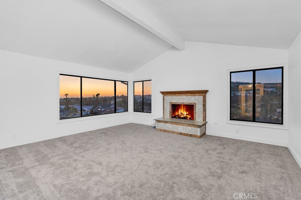 523 Calle Baranda San Clemente, CA 92673 - Photo 21 of 39 an empty room with floor to ceiling window and fireplace