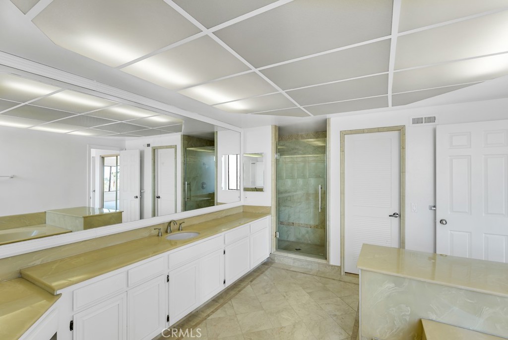 523 Calle Baranda San Clemente, CA 92673 - Photo 24 of 39 a large bathroom with a large mirror vanity and shower