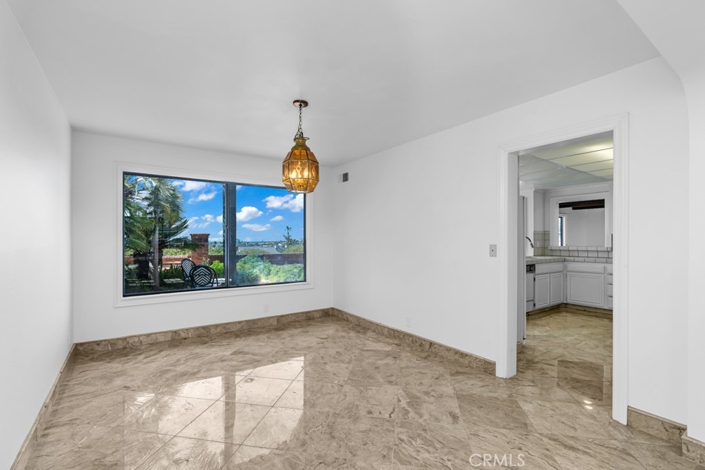 523 Calle Baranda San Clemente, CA 92673 - Photo 10 of 39 an empty room with a window and a kitchen view
