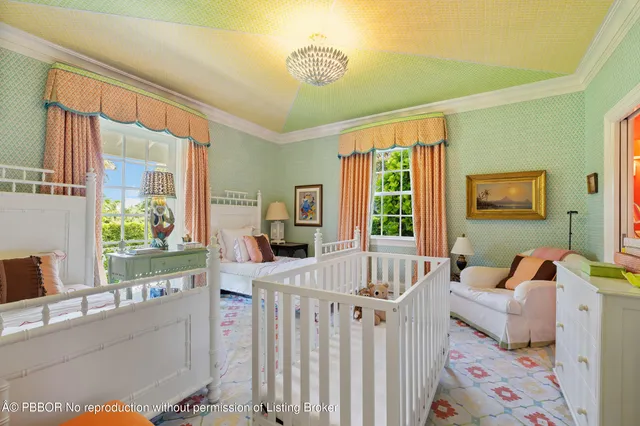 a bedroom with furniture and a large window