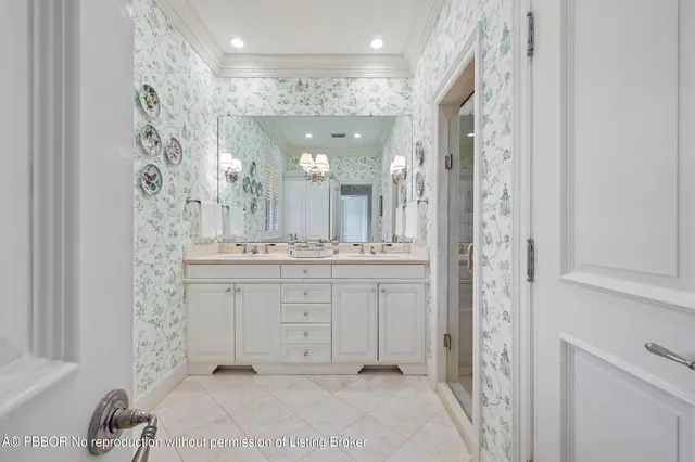 a bathroom with a double vanity sink mirror and shower