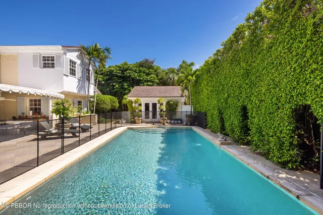 a view of a house with swimming pool and sitting area