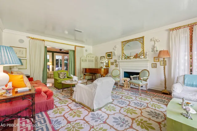 a living room with furniture a fireplace and a table