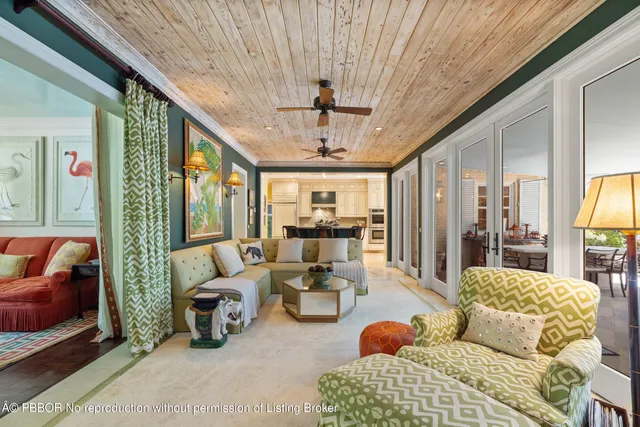 a living room with furniture ceiling fan and a rug