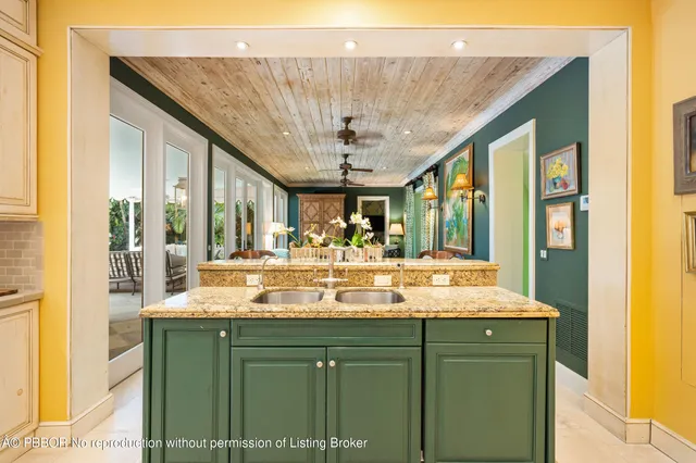 a bathroom with a granite countertop sink and a large mirror