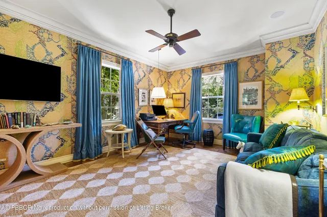 a living room with furniture a flat screen tv and a large window