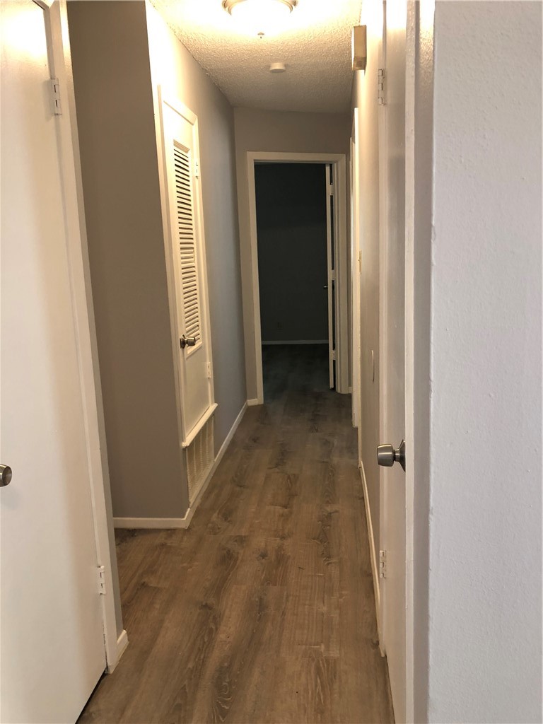 6502 South 1st Street, Unit 102 Austin, TX 78745 - Photo 16 of 26 an entryway of a house and wooden floor