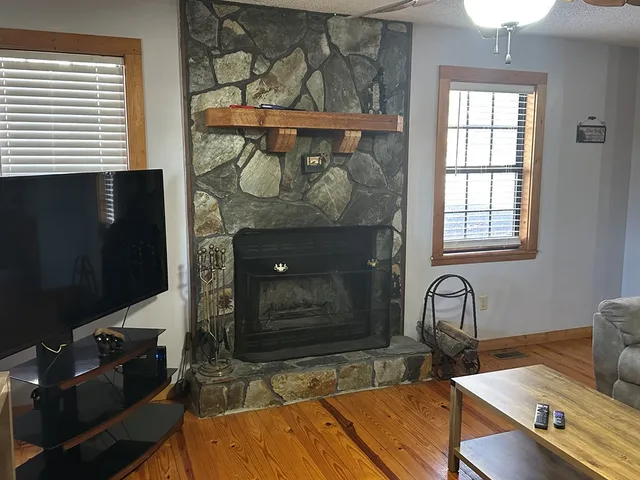 a room with wooden floor and a fireplace