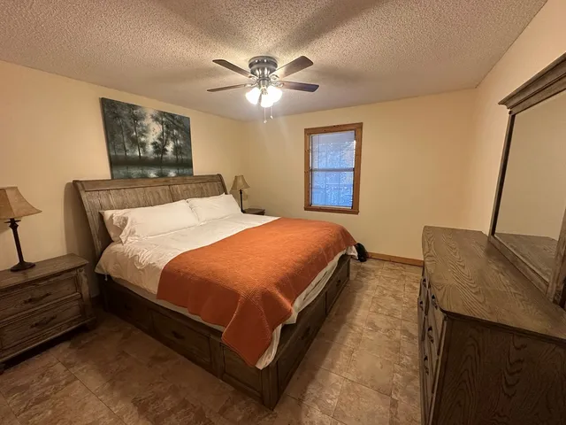 a bedroom with a bed and window