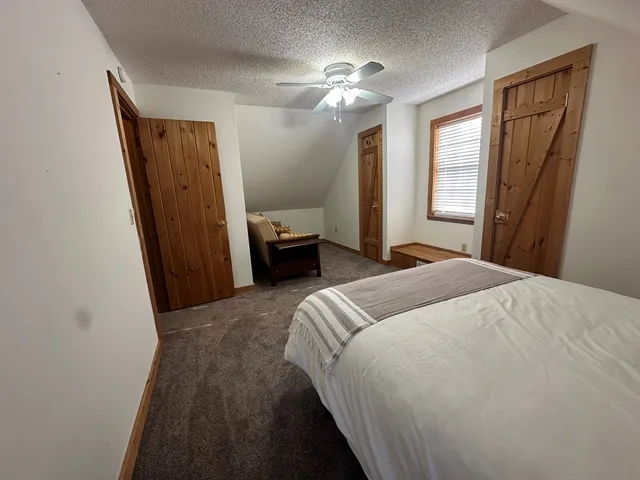 a bedroom with a bed and a mirror