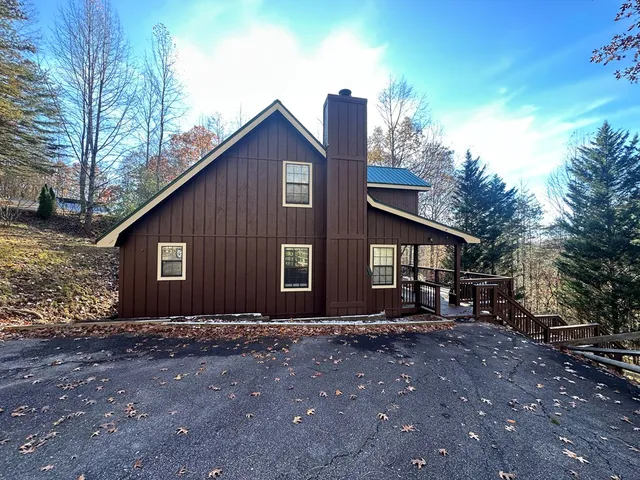 a front view of house with yard and trees