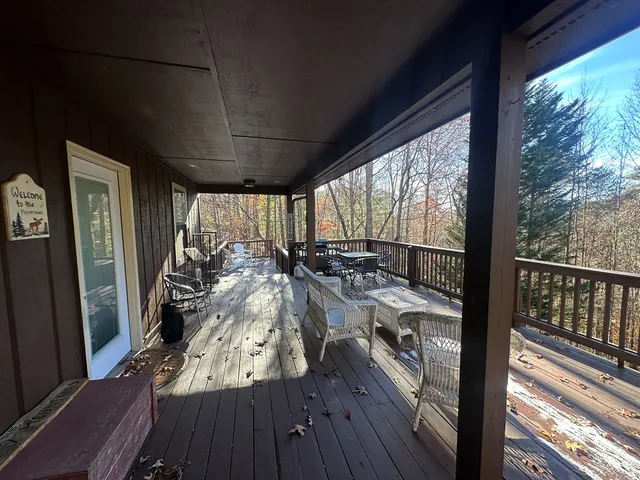 a view of a porch with wooden floor and iron fence