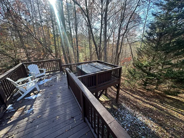 a roof deck with wooden floor and fence