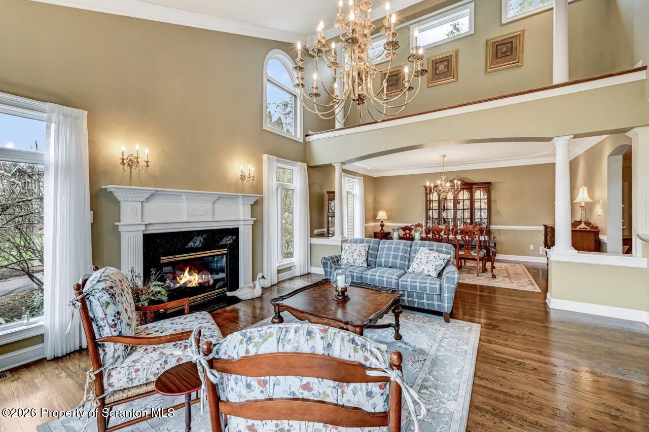 747 Greens Dallas, PA 18612 - Photo 15 of 98 a living room with furniture a chandelier and a fireplace