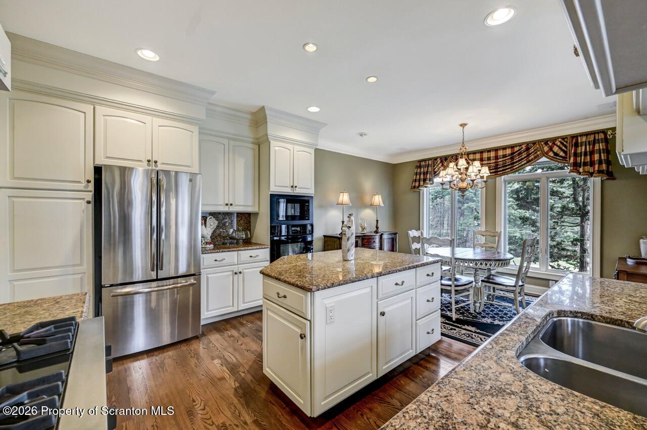 747 Greens Dallas, PA 18612 - Photo 22 of 98 a kitchen with a refrigerator a sink and cabinets