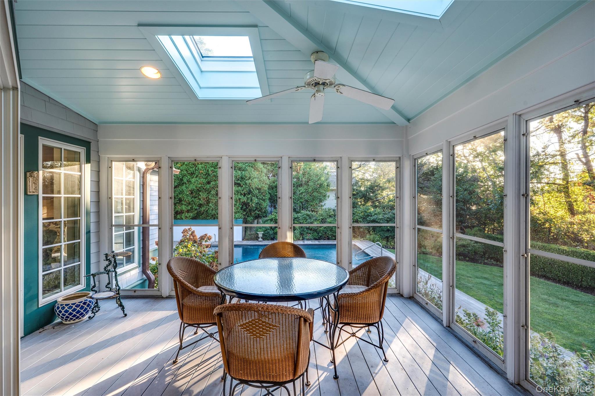 8 Fish Creek Lane Remsenburg, NY 11960 - Photo 11 of 35 Sunroom featuring a skylight, outdoor dining area, ceiling fan, and lofted ceiling