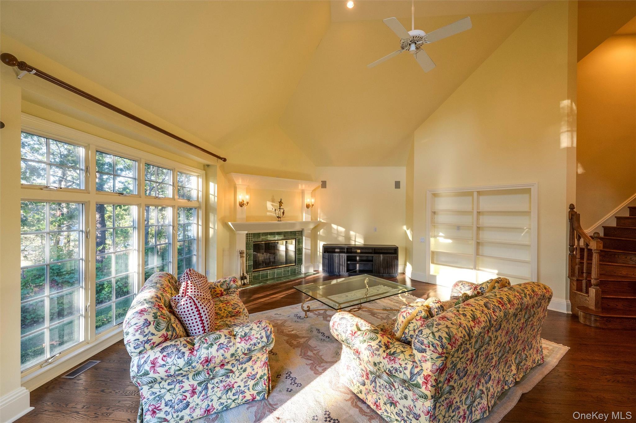 8 Fish Creek Lane Remsenburg, NY 11960 - Photo 19 of 35 Living area with a tile fireplace, high vaulted ceiling, stairs, dark wood-type flooring, and ceiling fan