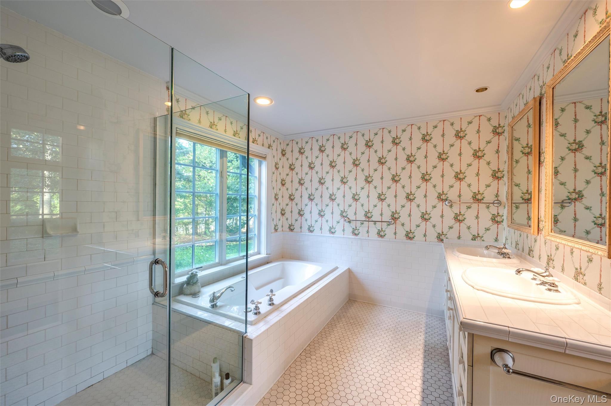 8 Fish Creek Lane Remsenburg, NY 11960 - Photo 22 of 35 Full bath featuring wallpapered walls, tile walls, a wainscoted wall, a stall shower, and a garden tub