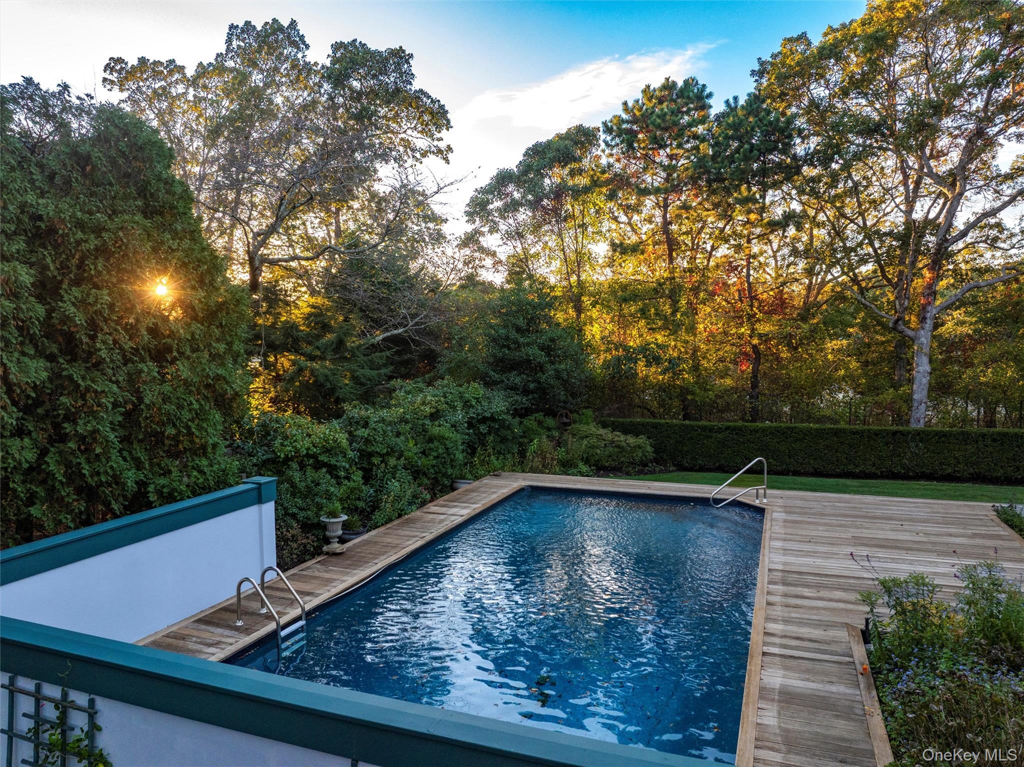 8 Fish Creek Lane Remsenburg, NY 11960 - Photo 28 of 35 Outdoor pool featuring a wooden deck