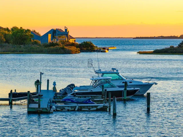 an aerial view of a house with swimming pool and lake view