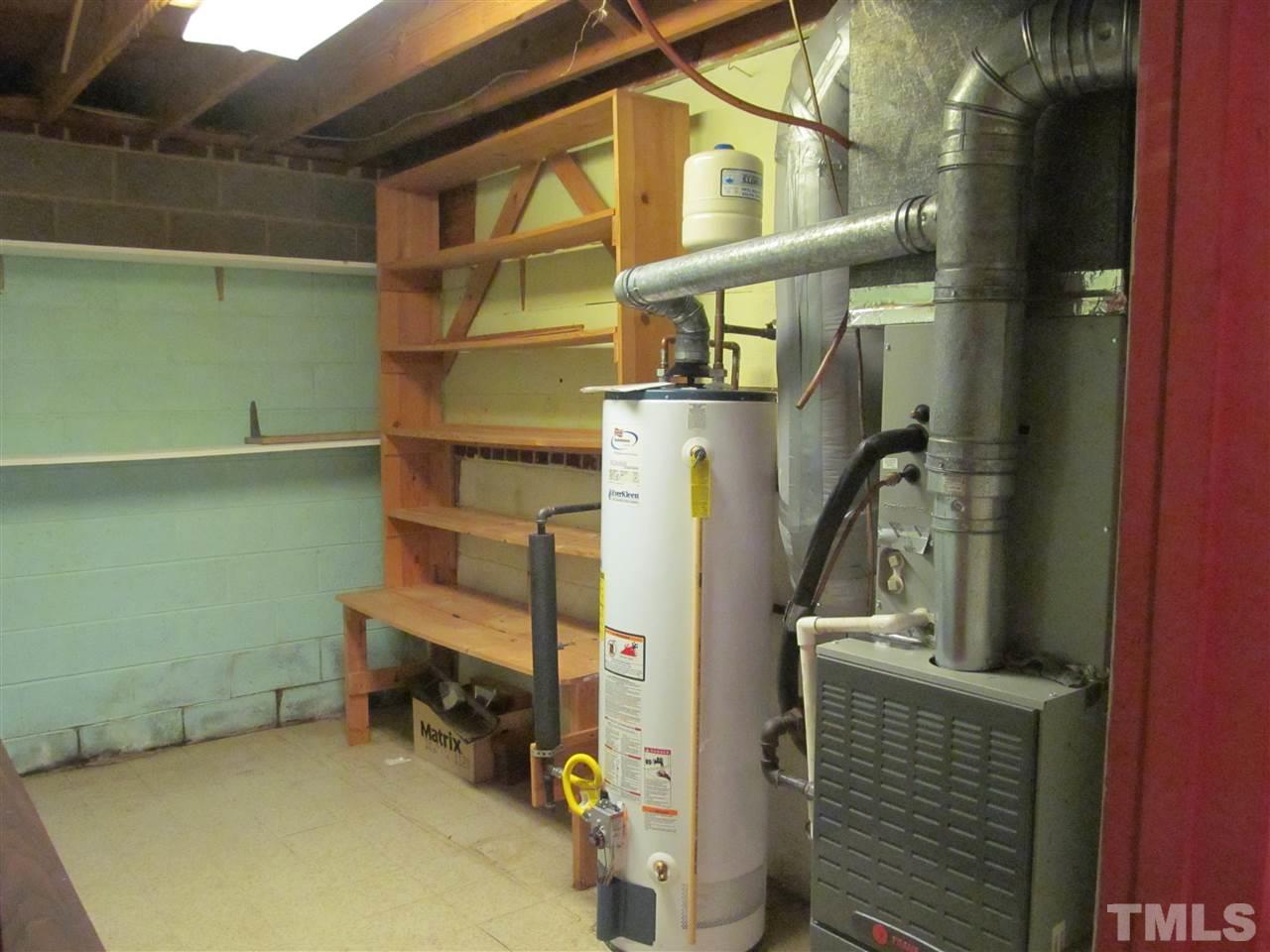 3409 Doyle Road Raleigh, NC 27607 - Photo 21 of 25 Workshop/storage area containing HVAC equipment and water heater.