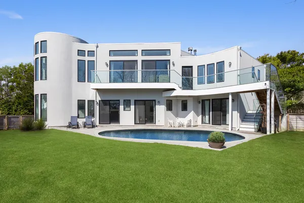 a front view of a building with a yard