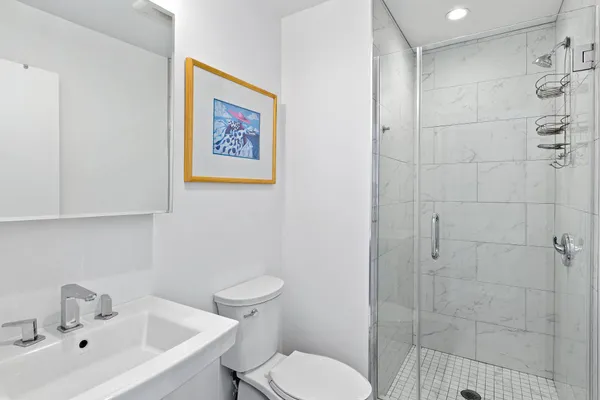 a white toilet sitting next to a bathroom sink