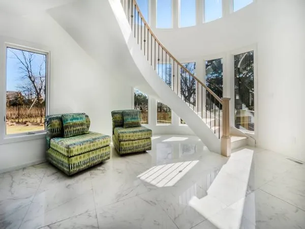 a living room with furniture and a stairs