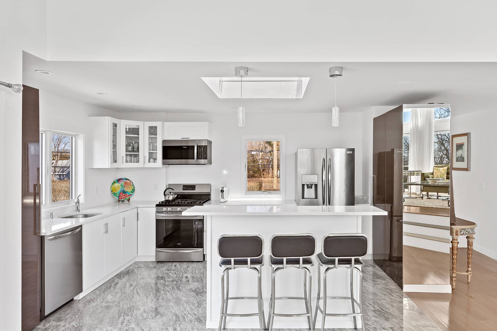 40 Bluff Road Amagansett, NY 11930 - Photo 5 of 16 a kitchen with stainless steel appliances kitchen island granite countertop a stove and a refrigerator