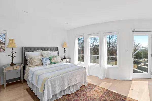 a bedroom with a large bed and a window