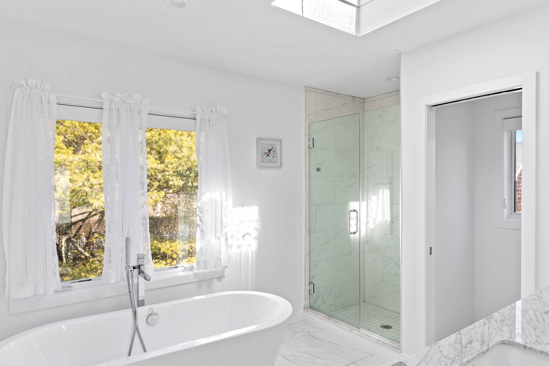 40 Bluff Road Amagansett, NY 11930 - Photo 8 of 16 a bathroom with a tub shower and window