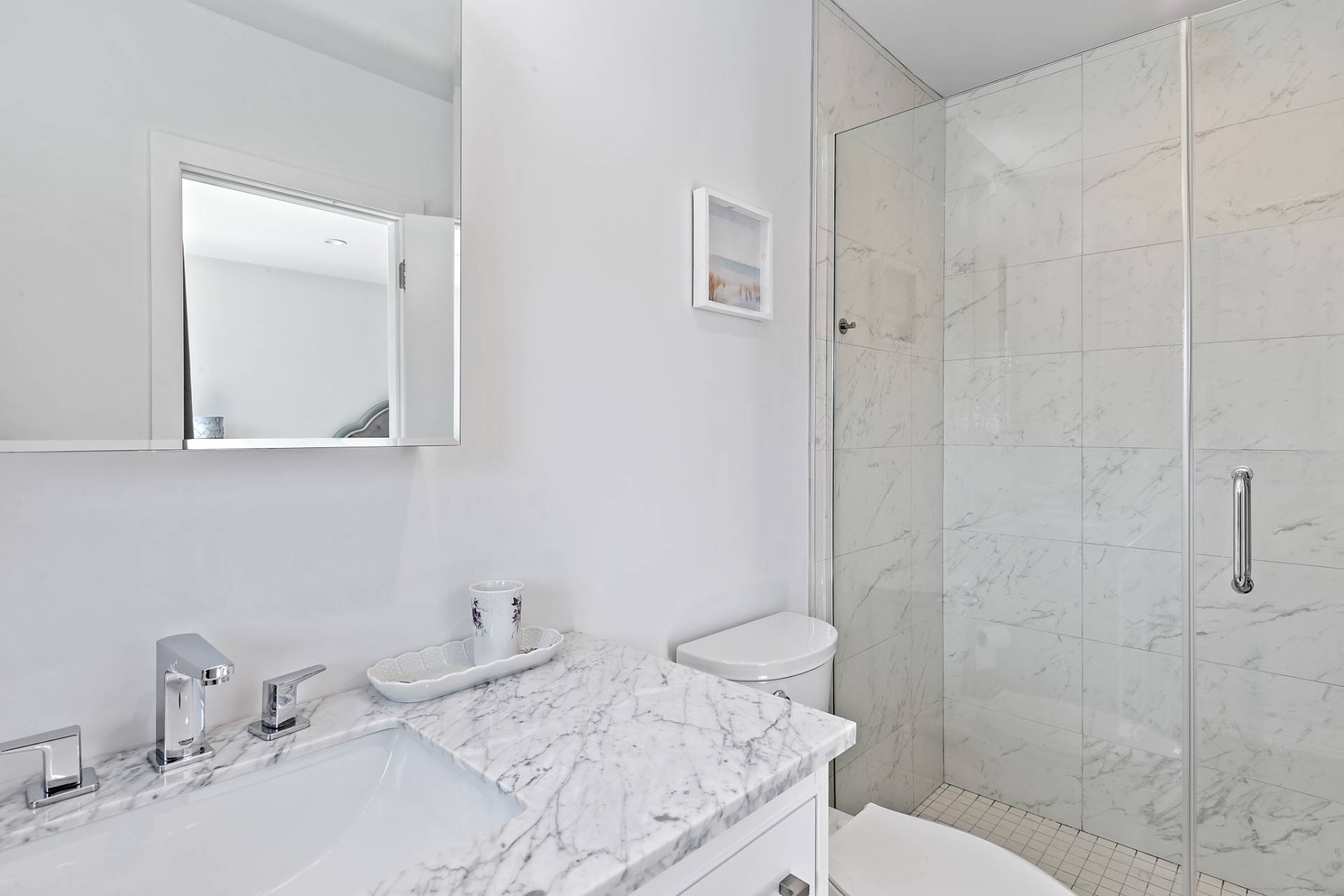 40 Bluff Road Amagansett, NY 11930 - Photo 9 of 16 a bathroom with a granite countertop sink a toilet and shower