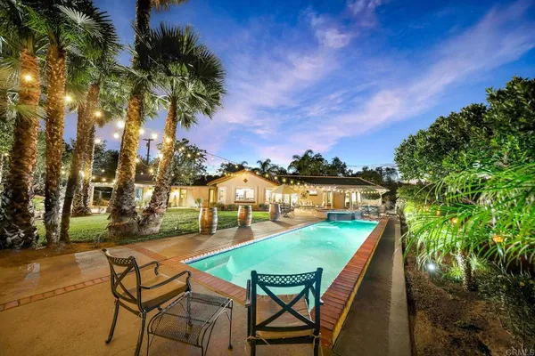 a view of swimming pool with lounge chairs