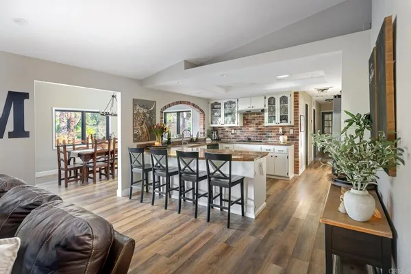 a kitchen with stainless steel appliances kitchen island granite countertop a refrigerator and a sink