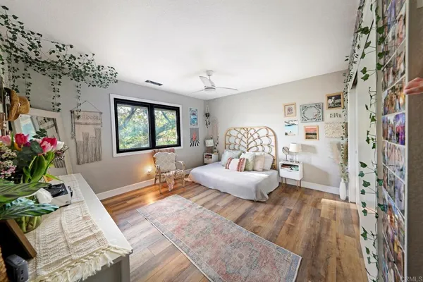 a bedroom with a large bed and a large window