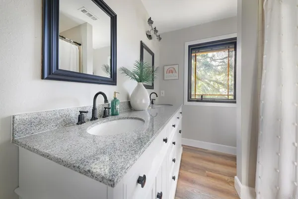 a spacious bathroom with a bathtub and a sink