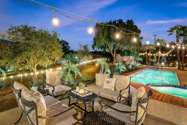 a view of a chairs and table in patio with a lake view